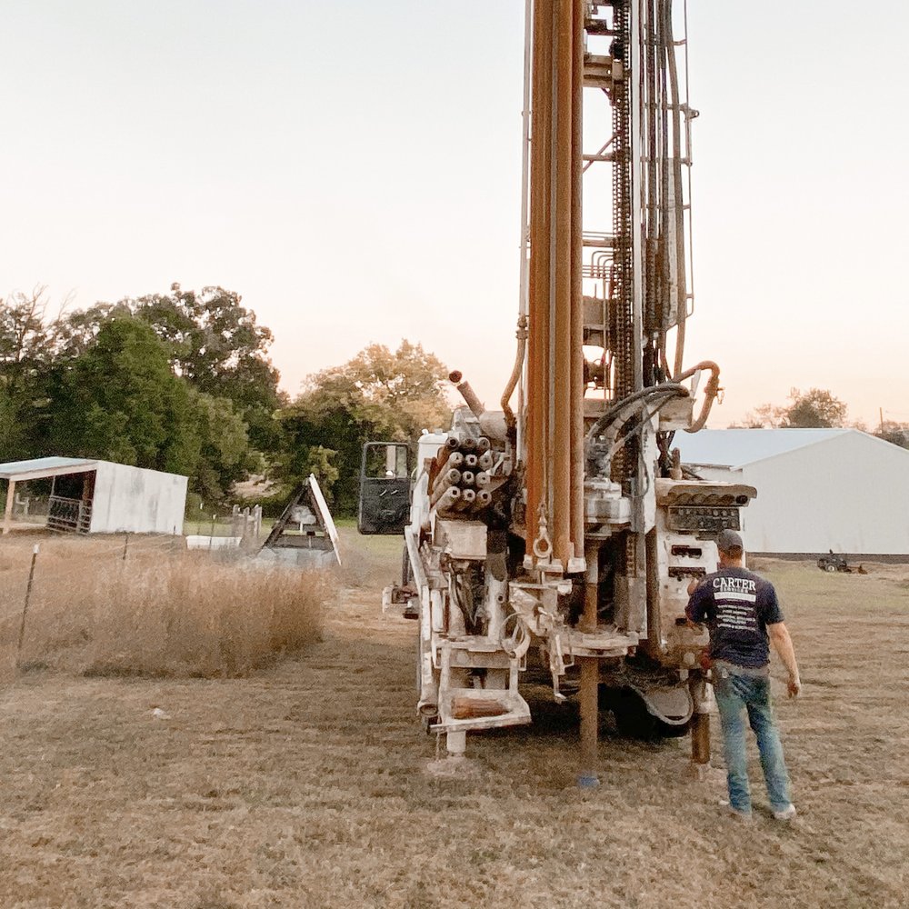 Water well drilling rig operating in Brent